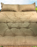 Self-inflating travel bed used outdoors on grass